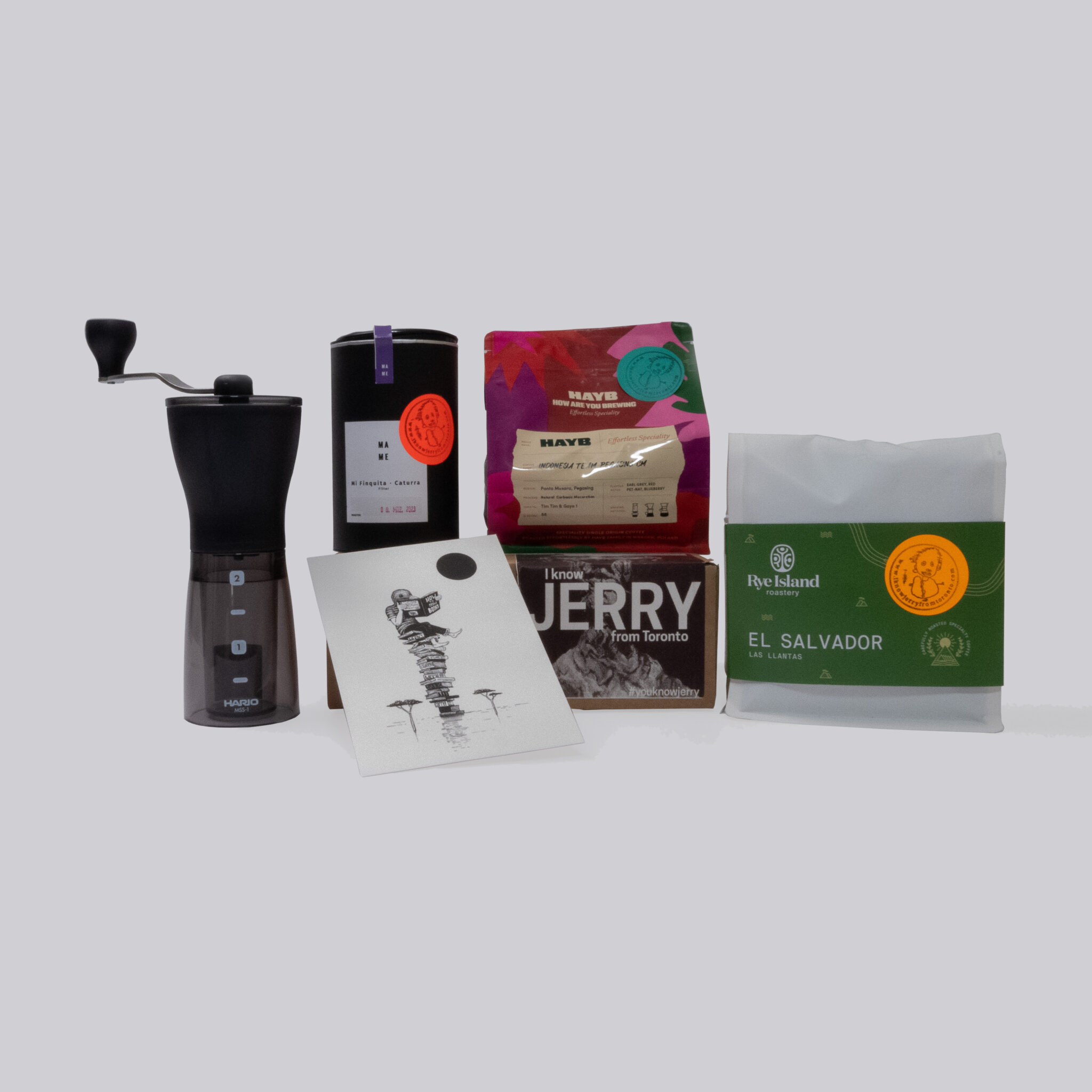 Packshot of the Grinder Box with coffee from Hayb, Rye Island, Mame and an artwork of Gijs Vanhee and a grinder from Hario