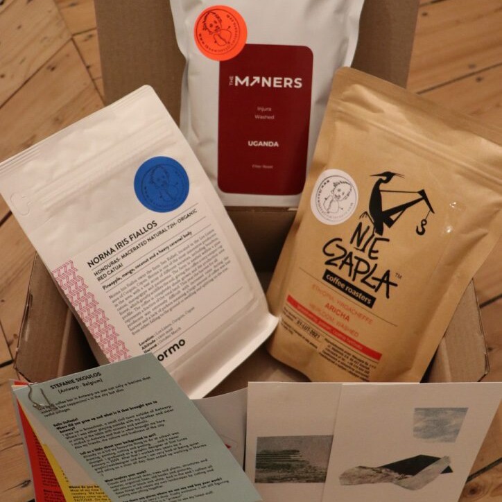 Bags of coffee beans of Nieczapla, The Miners, Normo and postcards of Stefanie Skoulos